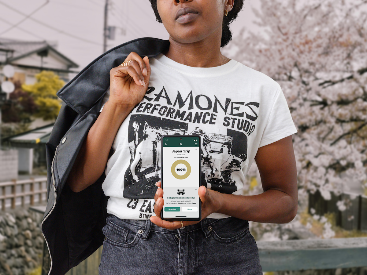 Woman in Japan holding Phone with Burrow App